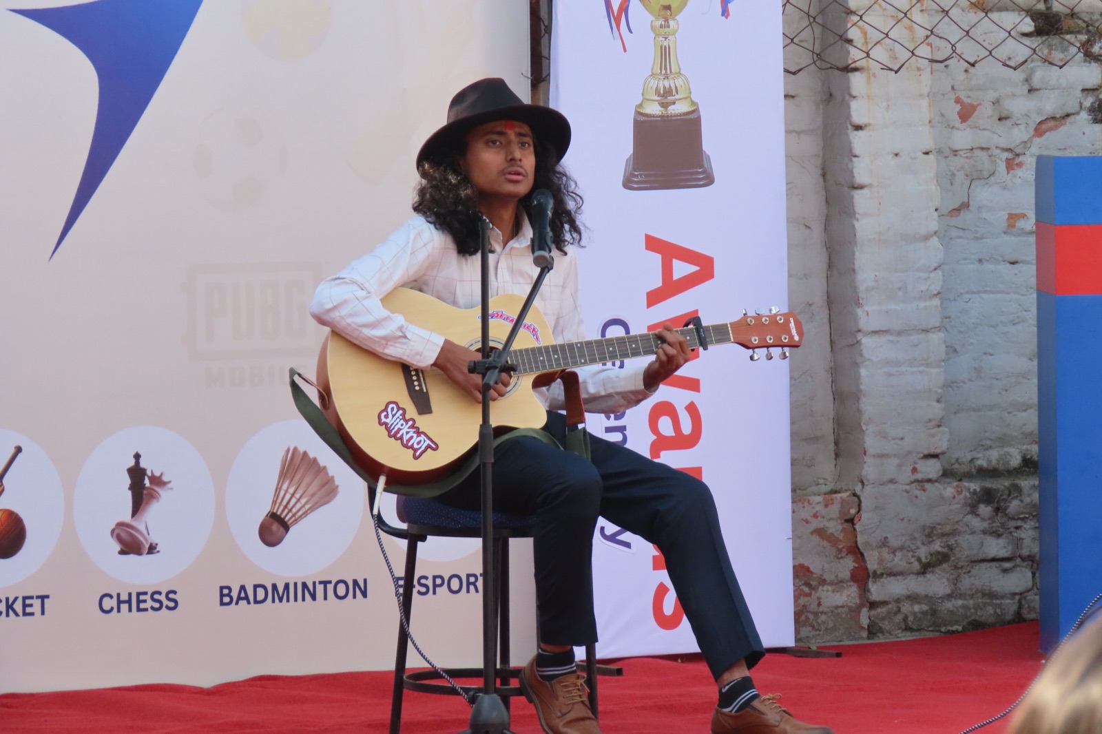 A student performing a live song at the Sports Week awards ceremony